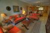 The well appointed living room opens up to the kitchen and dining area in unit 1203.